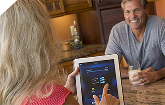Woman remotely adjusting the hot tub temperature using an app on her tablet